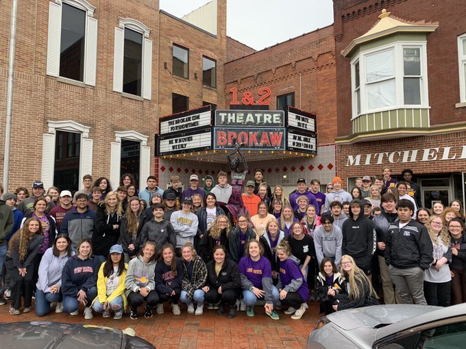 110 senoirs pose in front of the Brokaw Movie Theater