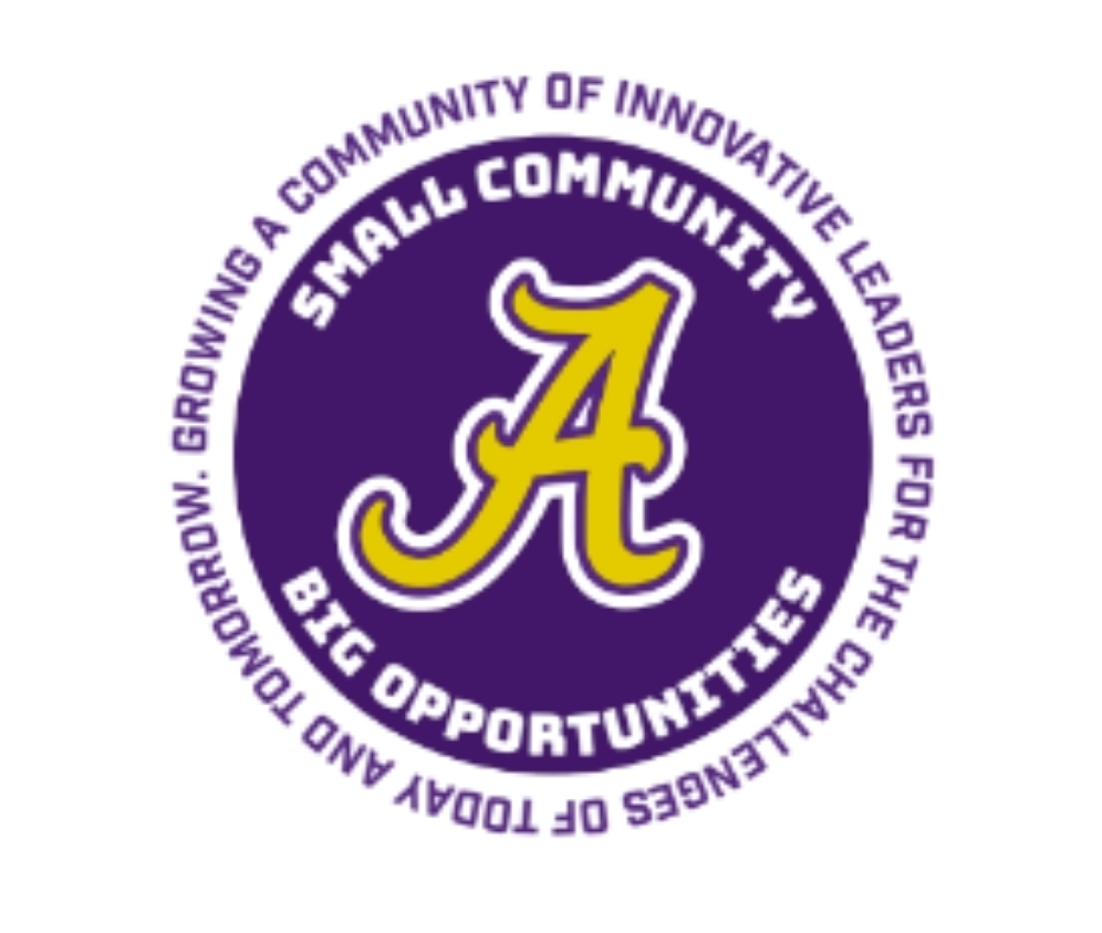 Purple circle with gold A in the middle. Inside the circle, the slogan small community, big opportunities. Outside the circle, the line Growing a community of innovative leaders for the challenges of today and tomorrow.