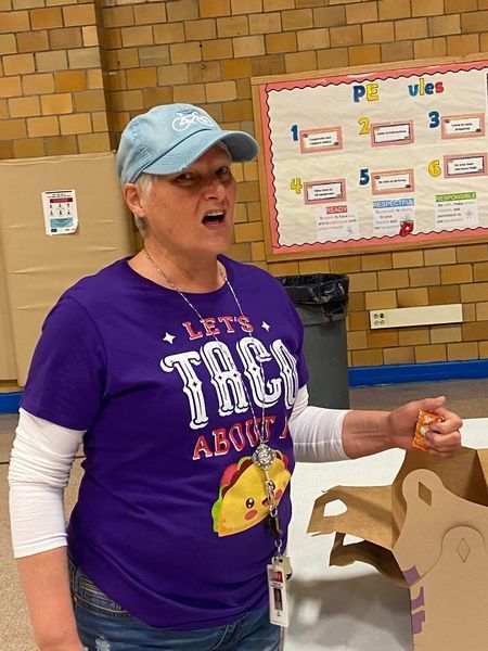 Guidance Counselor preparing tacos and wearing a taco shirt