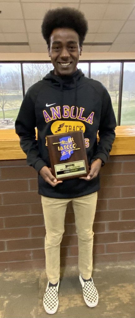 Izaiah Steury poses with a plaque