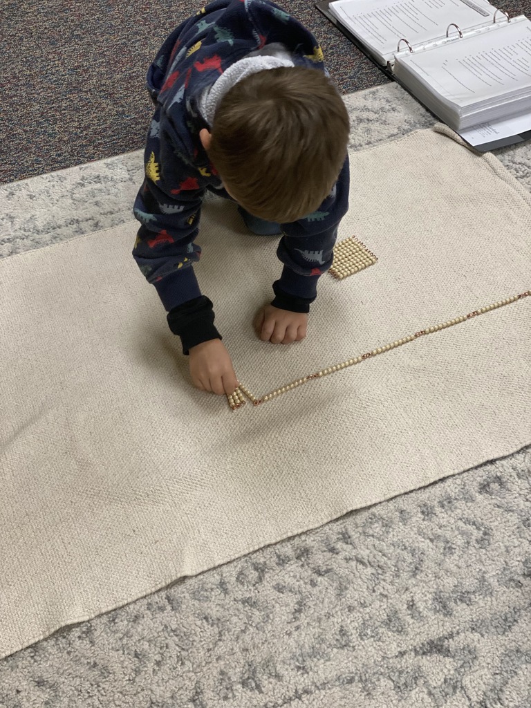 A child uses counting beads