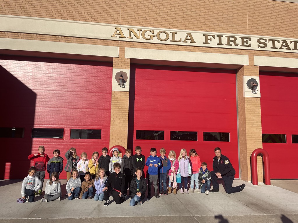 Children standing outside of a fire station