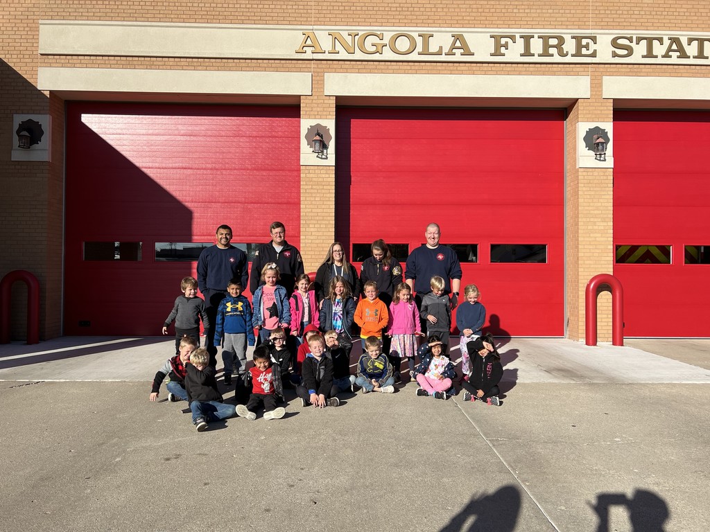 Children standing outside of a fire station